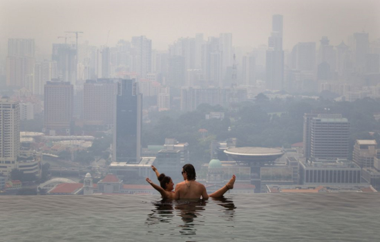 10月22日，一对情侣在新加坡戏水，无视笼罩天际的雾霾。