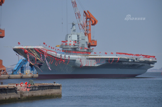 工人检查舰艏的情况:国产航母下水后继续施工