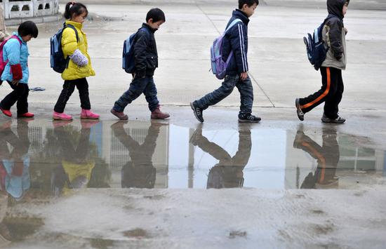 俊俊（右二）和小伙伴们走在上学的路上（2011年11月30日摄）。