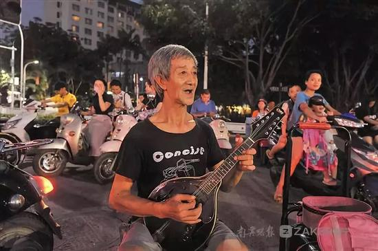 吴老坐在南宁街头弹唱