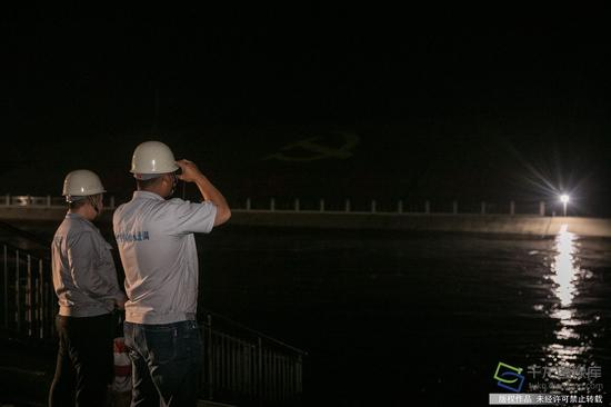 图为邵心杰检查闸口水位（5月16日摄 图片来源：tuku.qianlong.com）。千龙网记者 宋鹏飞摄