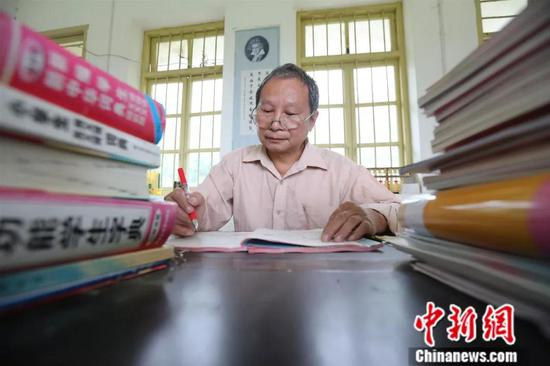 资料图：2017年9月8日，李朝文正在批改作业。