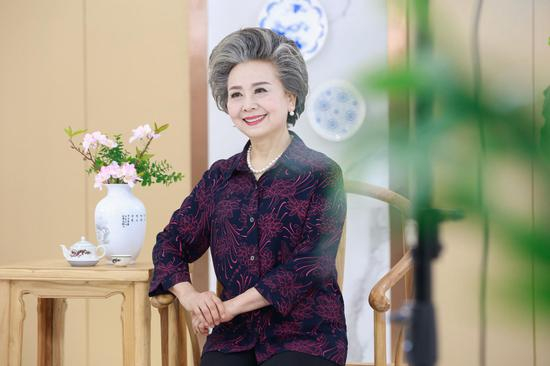 “朝八晚四”，杨光阿姨每天最多拍摄150套衣服。张迪 张孙超 摄