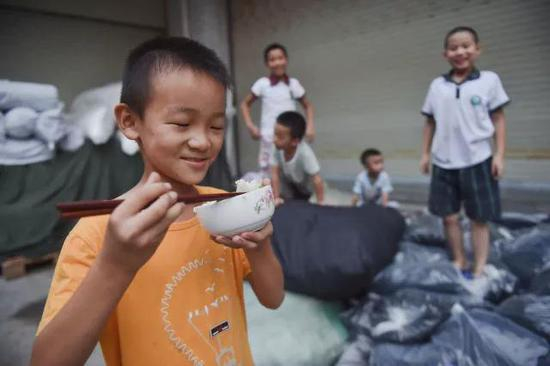 刘宇翔在车间外吃晚饭。