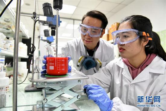 在烟台万华化学集团中央研究院先进表面材料中心，纪晓晓博士（右）和厉涛博士在做水性环保甲油实验（2018年12月8日摄）。新华社记者 郭绪雷 摄
