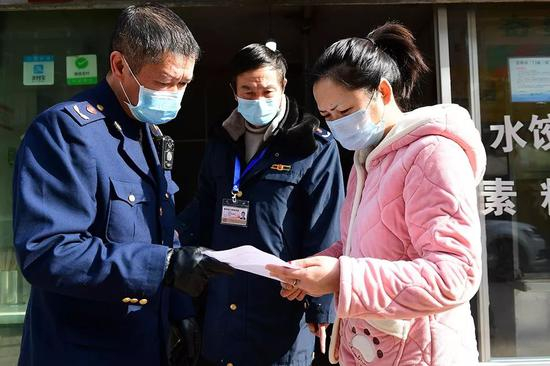  1月29日，贵阳市乌当区东风镇，市场管理人员上门与辖区经营户签订《抗击新型冠状病毒感染的肺炎疫情的责任书》。（新华社图）