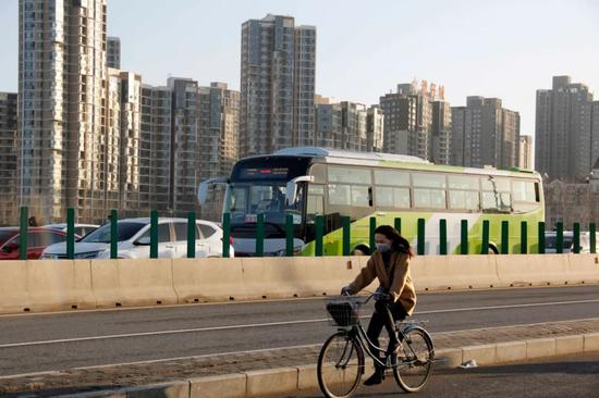  013县道，一位女士骑自行车进京。