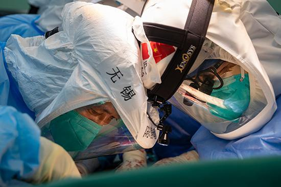 4月24日，武汉协和医院器官移植中心主任董念国（前右）和江苏省肺移植中心主任陈静瑜（前左）在为患者实施肺移植手术。 新华社记者 沈伯韩 摄