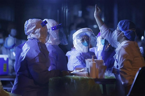  8月2日夜间，在暴雨中，心圆西苑进行了首次全员核酸检测，与“德尔塔”病毒抢时间。图片来源：视觉中国