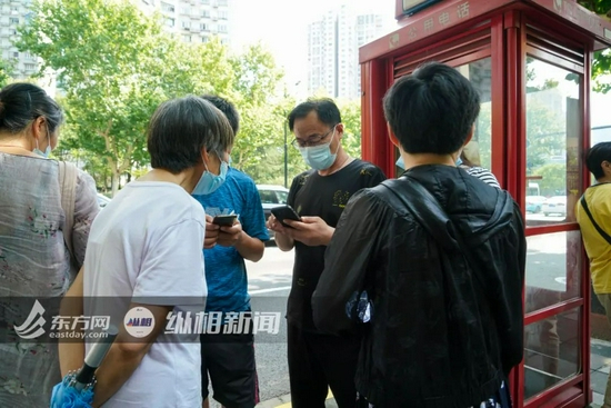 （图说：受害者父亲老刘与亲朋在法院外等待开庭宣判。蔡黄浩 摄）