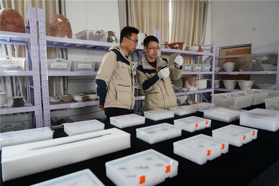 考古队员在研究河北雄安新区南阳遗址的出土器物（2021年3月19日摄）。新华社记者 牟宇 摄