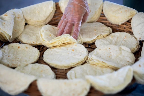  4月30日，山东淄博，高青县一家食品加工企业内，工作人员赶制小饼订单。图/视觉中国