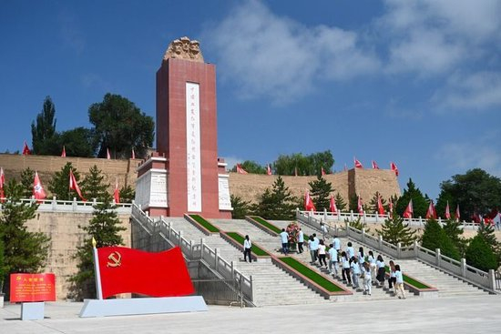 在宁夏固原市西吉县，大学生向中国工农红军长征将台堡会师纪念碑敬献花篮（2024年8月1日摄）。新华社记者 毛竹 摄