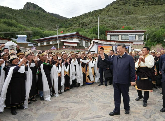  7月21日下午，习近平在林芝市巴宜区林芝镇嘎拉村考察时，向村民们挥手致意。新华社记者 李学仁 摄