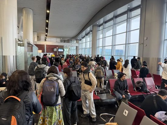 　从利雅得飞往马尼拉的航班延误，不少旅客站着等待，期盼快点起飞（董先生提供）
