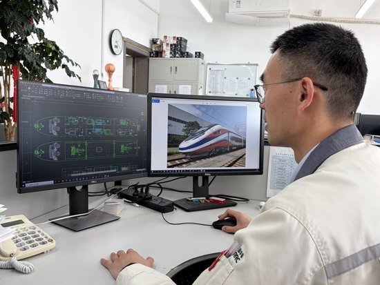 2026年3月6日，在中车大连机车车辆有限公司，张彦民正在办公桌前查看设计图。新华社记者 武江民 摄