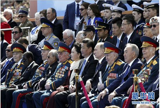 　　图为：2015年5月9日，俄罗斯举行纪念卫国战争胜利70周年盛大庆典。国家主席习近平和来自世界约20个国家和地区及国际组织领导人出席庆典。这是习近平和夫人彭丽媛同普京等领导人出席红场阅兵仪式。新华社记者 鞠鹏 摄