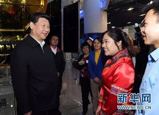 习近平和在展厅参观的优秀青年代表交谈。