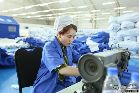 工作人员佐日古丽在加工帐篷（7月6日摄&nbsp;图片来源：tuku.qianlong.com）。千龙网记者&nbsp;许珠珠摄