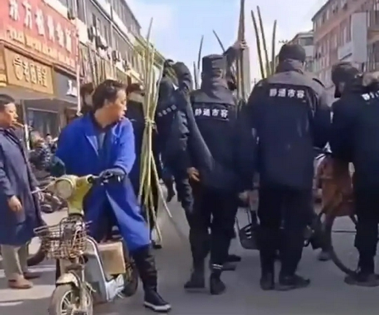  ▲12月6日，江苏南通市海门区三星镇叠石桥，多名身穿“静通市容”制服的工作人员围住路边卖甘蔗的老人。视频截图