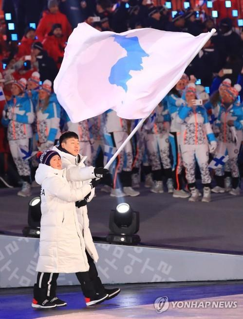 平昌冬奥会上，朝韩选手举统一旗共同入场。（韩联社）