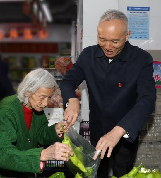  帮85岁高龄的吴慧英老人挑菜，询问菜价贵不贵