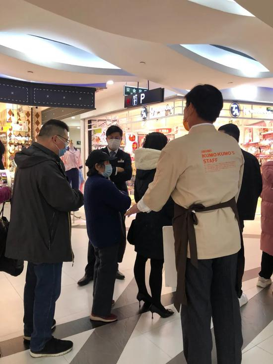  店员正在阻止反复排队的“黄牛”&nbsp;摄影| 刘立言