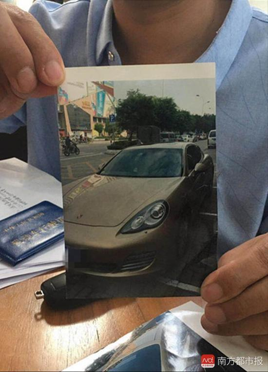 当事人廖先生出示他曾“购得”的保时捷。车已被债权人拖走。