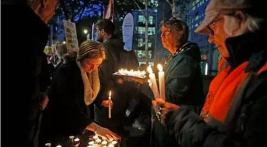  部分英国民众在英国内政部外自发为39名逝者举办追思会。