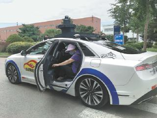  乘客试乘体验自动驾驶出租车。　　孙奇茹摄