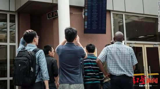 △一队中国人在肯尼亚内罗毕机场查看到达航班时刻表。图据CNN
