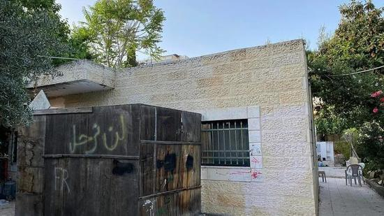  （图说：谢赫贾拉一户巴勒斯坦人家外墙写着：“我们绝不离开。”&nbsp;图/Osama Eid）