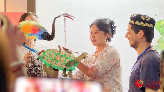 在昌吉美术馆,中外汉学家、翻译家、作家参观非遗展厅,观看、体验非遗项目。人民网 李欣洋摄