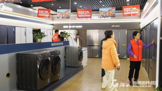  12月18日，在沙雅县一家家电专卖店，消费者正在选购家电。艾克热木摄