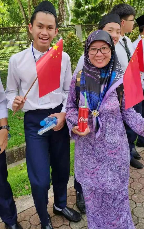 △女生戴头巾，男生戴宋谷帽，欢迎习近平主席。（央视记者耿小龙拍摄）