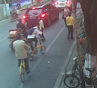 ▲黄某被同向骑行的唐某的唾液溅到身上后，扭头回看唐某。