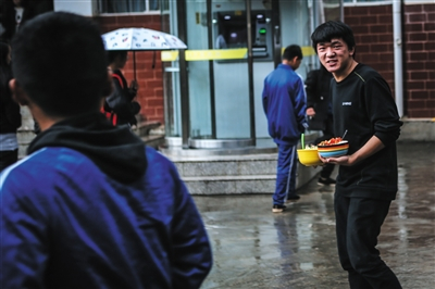 　　12月19日，禄劝一中，耿加寿拿着午饭准备去教室吃。除了晚上在宿舍睡觉，他几乎都在教室里看书做题。