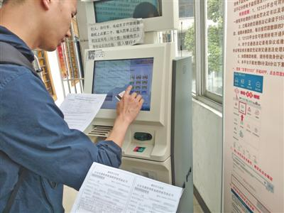 5月13日，湖北襄阳，一名司机用自助机缴纳交通违法罚款。 资料图片/IC photo