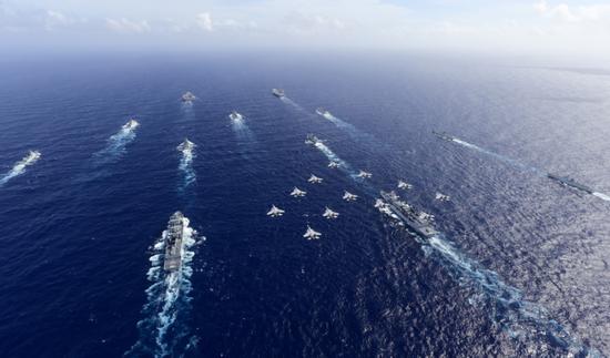 歼-15及其改进型号编队飞越航母战斗群上空,这是海军大国才能拥有的全家福。