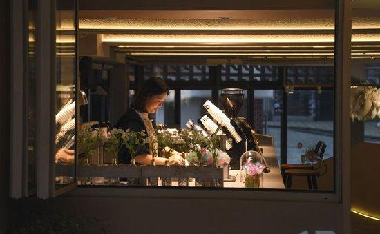 2024年4月22日，在重庆市九龙坡区谢家湾街道民主村社区，饮品店工作人员在店内忙碌。