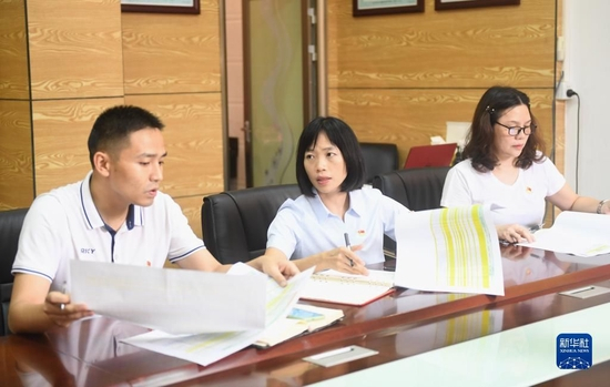 陆秀兴（中）与佛山市禅城区张槎街道古灶村“两委”班子同事开会交流（2022年9月7日摄）。新华社记者 卢汉欣 摄