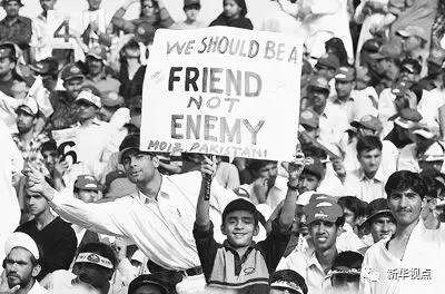  图为在巴基斯坦拉瓦尔品第举行的一场巴基斯坦队与印度队的板球比赛中，一名当地男孩举起了“我们应该是朋友而不是敌人”的标语。 图片来自网络