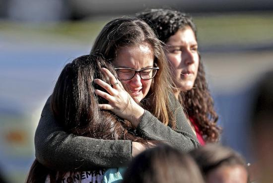 ▲2月14日，在佛罗里达州发生枪击的高中，安全撤离的学生相拥而泣。 图/新华社