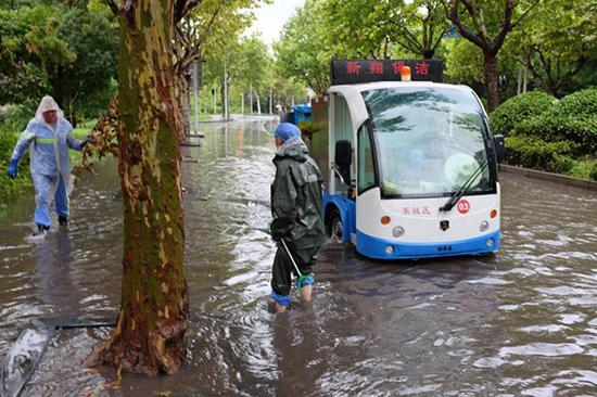 上海嘉定区，环卫工人处理路面积水。嘉定区供图