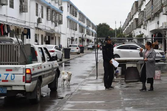 　　▲当着主人的面，执法队员没有强行收容放养状态的狗，而是对主人进行了文明养犬的宣传。受访者供图