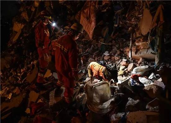 12月20日，消防官兵在利用搜救犬搜救。新华社记者 毛思倩摄