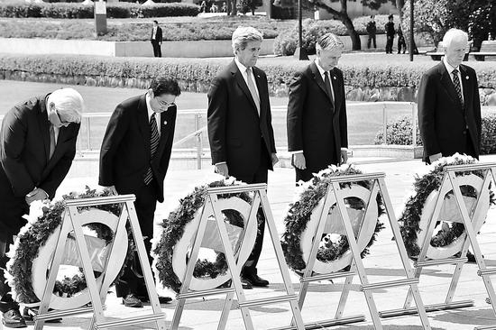 在广岛死难者纪念碑前献花圈时，克里站在众外长中间，但没有鞠躬。