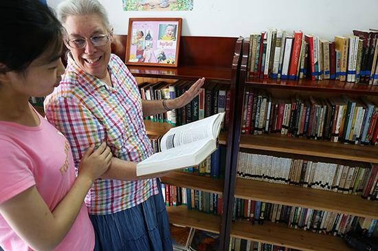 2014年9月3日，埃斯特在“客厅图书馆”向学生介绍英文书籍。 江伟涛/视觉中国 资料图