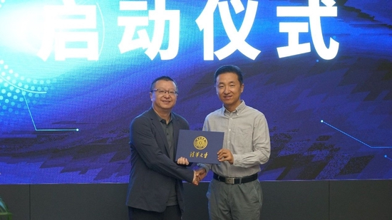 微博COO王巍从清华大学新闻与传播学院党委书记胡钰手中接过业界导师聘书。