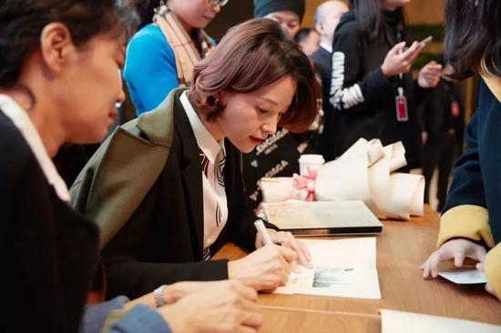 ▲活动现场，董卿认真仔细的为读者签名（图/主办方文轩BOOKS）